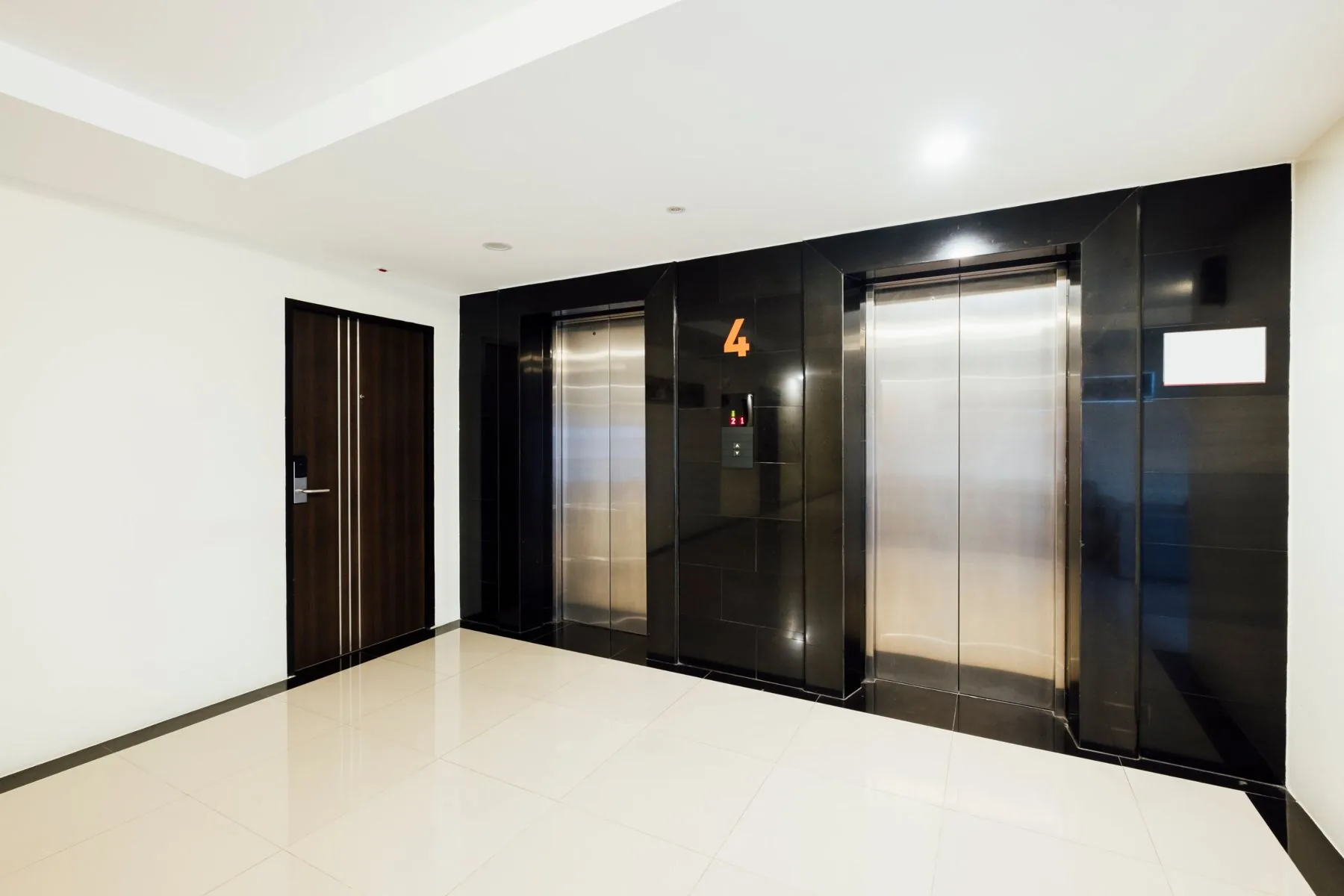 Commercial lift lobby with two stainless steel lift doors