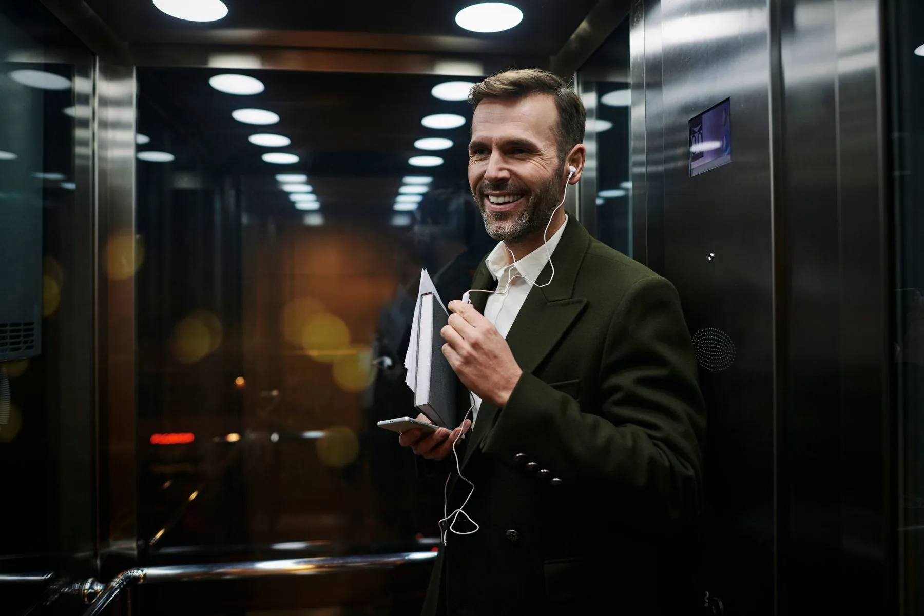Passenger riding a modern stainless steel lift